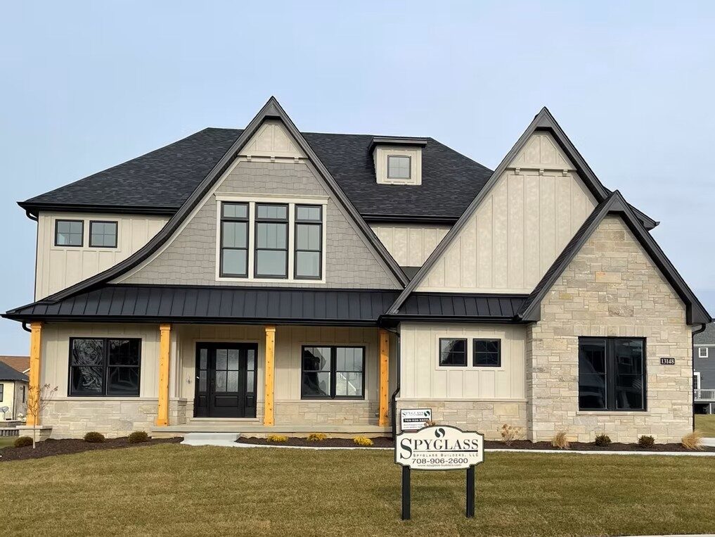 Modern cottage custom home with board-and-batten siding, cedar timber porch posts and stone accents built by Spyglass